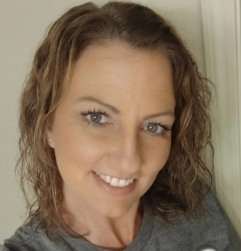 Amy smiling with naturally curly hair