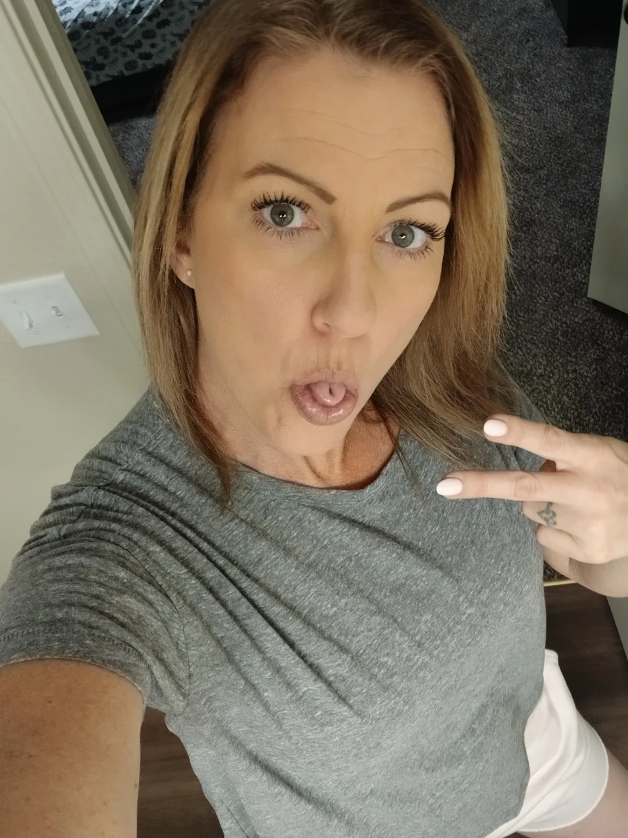 Amy making a playful face and flashing a peace sign