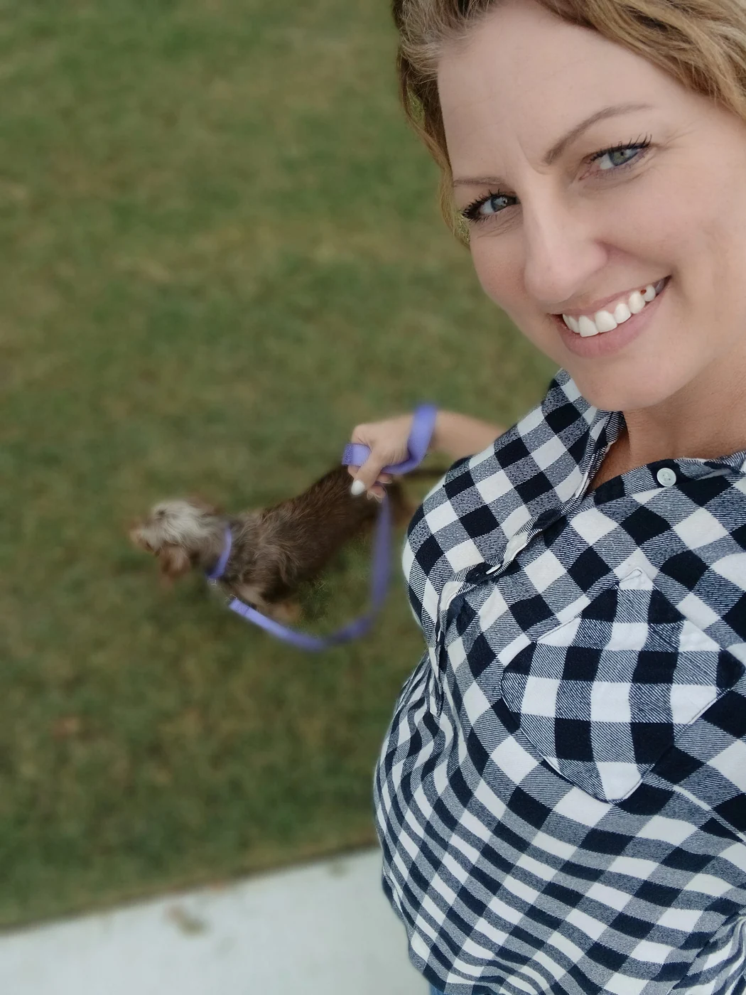 Amy smiling while walking her dog on an ordinary day