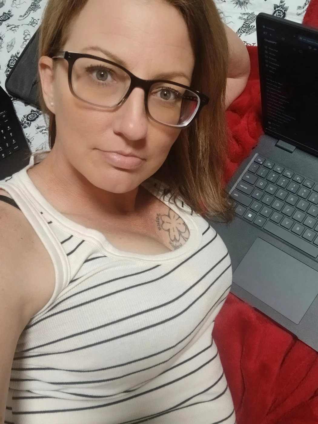 Amy relaxing beside her laptop while writing
