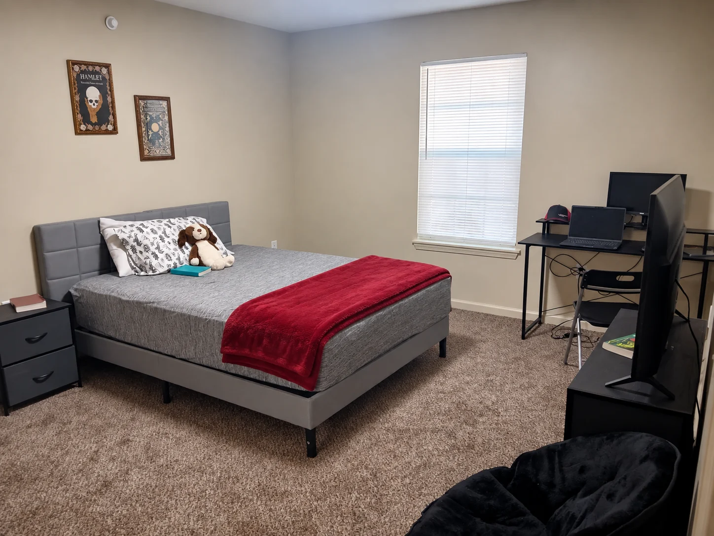 Amy's room, with a made bed, desk, and window